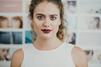 Happy woman in bold red lipstick stands confidently