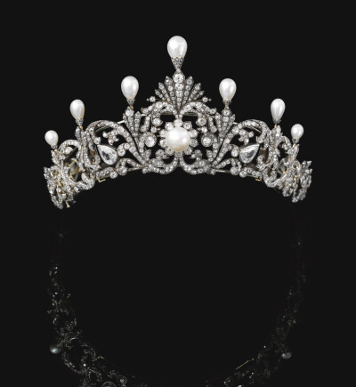 Natural pearl and diamond tiara, late 19th century
Of foliate scroll design, surmounted with seven drop-shaped natural pearls each in a mount embellished with rose diamonds, graduated in size from the…