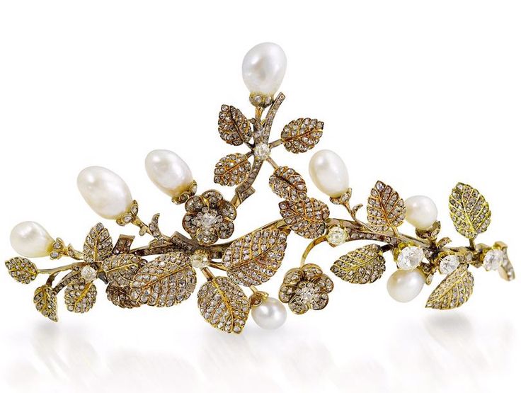 A pearl and diamond tiara/brooch combination, circa 1900. The realistic floral and foliate spray set throughout with old brilliant and rose-cut diamonds, issuing baroque pearl buds, pearls untested for natural origin, later brooch fitting, diameter 10.5cm. 