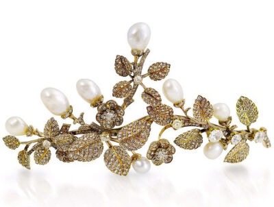 A pearl and diamond tiara/brooch combination, circa 1900. The realistic floral and foliate spray set throughout with old brilliant and rose-cut diamonds, issuing baroque pearl buds, pearls untested fo…