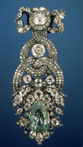 The 41 carat Dresden Green diamond, one of the few green diamonds that is known to be of natural color, in a hat ornament made by Prague jeweler Diessbach in 1768. The flowery bot