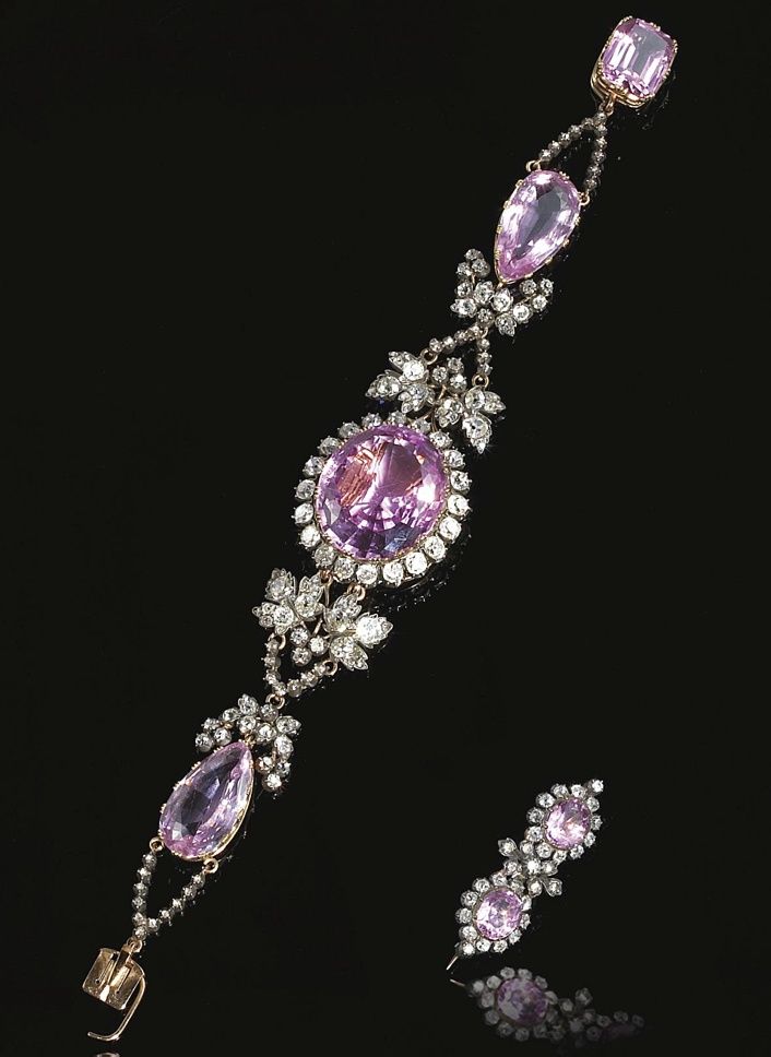 RARE PINK TOPAZ AND DIAMOND BRACELET, CIRCA 1830. The central oval pink topaz set within a border of old-mine diamonds, on an articulated bracelet set with two pear-shaped pink to