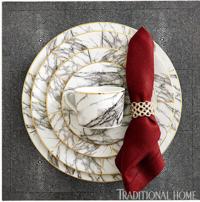 Get this marbled look: “Keon” napkin ring in tarnished silver. “Elini” marble-inspired porcelain dinnerware with gold edge. “Henry” faux shagreen square placemat in cool gray. All from Blue Phea…