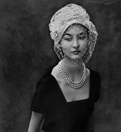 Model in hat by Claude St. Cyr, dress by Jean Dessès, pearl necklace by Sterlé, photo by Georges Saad, 1957