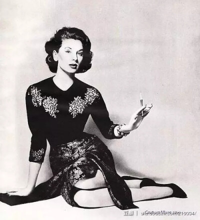 Suzy Parker wearing a dress and cashmere sweater by Sophie of Saks, 1958. Photo by Richard Avedon.