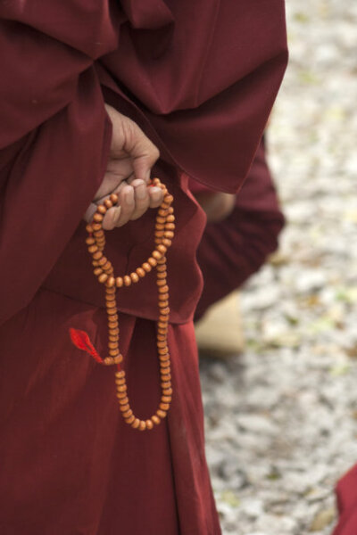 Monk's hand with beads