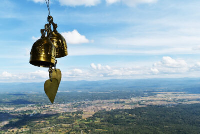 two golden bell in front of mountain and blue sky