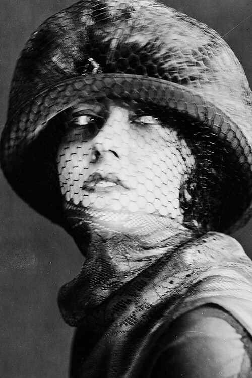 circa 1925: American actress Gloria Swanson (1899 - 1983) wearing a hat with a veil covering her face. 