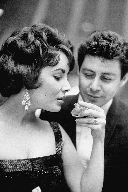 Elizabeth Taylor and Eddie Fisher attend the premiere of Smellovision, photographed by Art Shay, 1960.