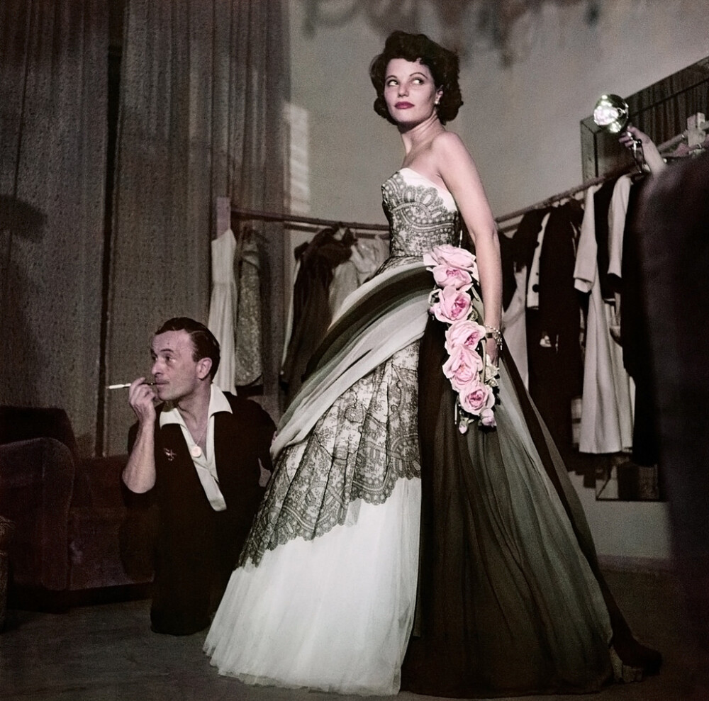 Actress Geraldine Brooks trying on a dress at the fashion house of Emilio Schuberth, Rome, August 1951.