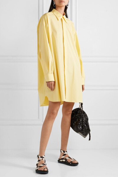 Maison Margiela 这款大廓形衬衫不论是罩在裤装之上，还是穿作迷你连衣裙，都一样时髦有型。单品采用纯棉府绸制于意大利，浅黄色调清新雅致。它配有利落的尖领，更以落肩设计巧妙凸显出衣身的松垮，散发出迷人的休闲…