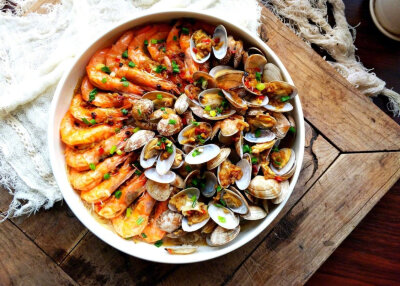 【蒜蓉粉丝蒸双鲜（蒜蓉粉丝蒸花甲虾）】
“蒸过之后花甲开口了，虾背也展开了，再淋酱料，淋的时候沿着盘边由四周向盘子中心均匀划圈，这样所有的地方基本都能淋到啦。清蒸的虾和花甲原汁原味，是非常健康的美味哦…